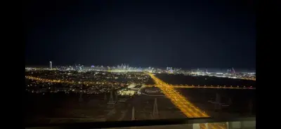 a view of a city at night with lights at Binghatti Onyx - Upgraded One Bedroom in JVC in Dubai