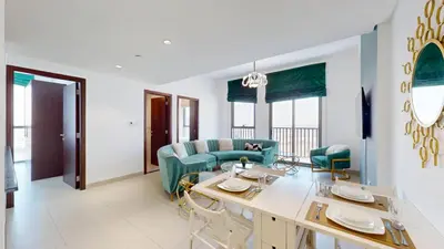 a living room with a table and a couch at Vacationer I Exclusive 2 Bedroom I Breathtaking Skyline & City Views I Afnan 1 - IMPZ in Dubai