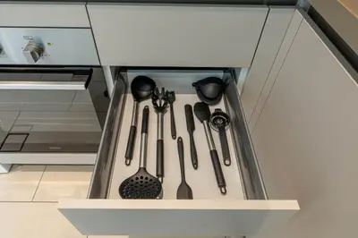 a drawer filled with utensils in a kitchen at Stylish 1BR with Pool, BBQ Area, Gym in MBR City in Dubai