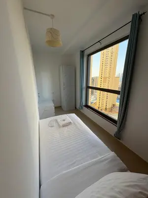a bedroom with a bed and a large window at Horizon JBR in Dubai