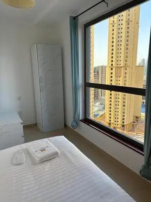a bedroom with a bed and a large window at Horizon JBR in Dubai