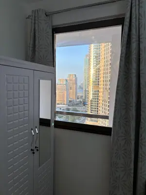 a room with a window with a view of a city at Horizon JBR in Dubai