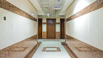 a hallway with a row of doors in a building at Elegant Studio Near Burj Khalifa Pool and Gym in Dubai
