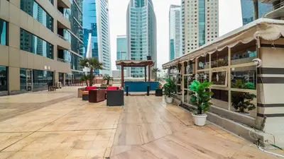 a patio in a city with tall buildings at Elegant Studio Near Burj Khalifa Pool and Gym in Dubai