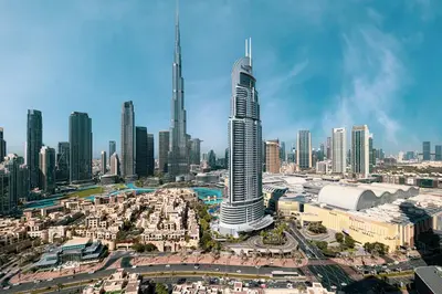 an aerial view of a city with a tall skyscraper at Burj & Fountain View 5-Min Walk to Dubai Mall in Dubai