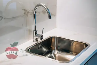 a kitchen sink with a stainless steel faucet at Stylish studio in Azizi 42 in Dubai