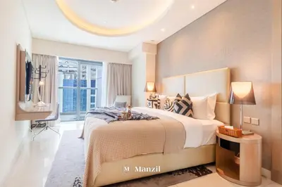 a bedroom with a large bed and a tv at Luxury 1BR Apartment in Paramount Top-Floor Retreat in Dubai