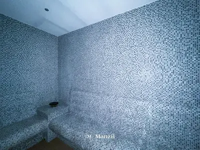 a bathroom with a white tiled wall at Luxury 1BR Apartment in Paramount Top-Floor Retreat in Dubai