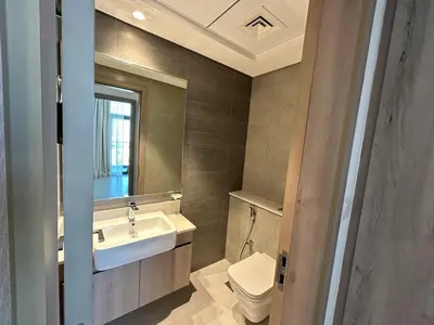a bathroom with a sink and a toilet and a mirror at Beautiful view, fully-equipped apartment in Dubai
