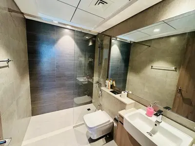 a bathroom with a toilet and a sink and a mirror at Beautiful view, fully-equipped apartment in Dubai