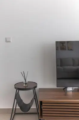 a living room with a table and a tv at Beautiful view, fully-equipped apartment in Dubai