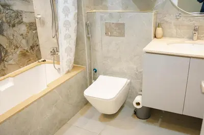 a bathroom with a toilet and a shower and a sink at Zapbed House-Cozy 2 BR Apartment In The Greens Golf View in Dubai