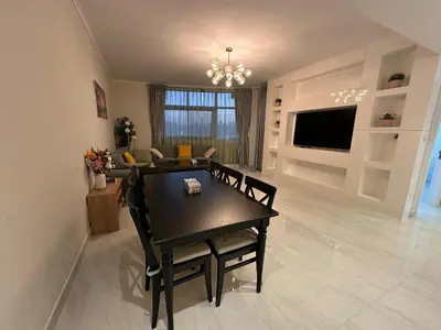 a living room with a table and a couch at Zapbed House-Cozy 2 BR Apartment In The Greens Golf View in Dubai
