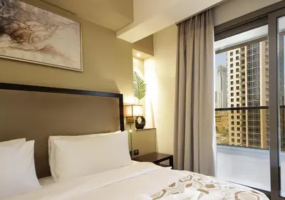 a bedroom with a bed and a large window at Luxury 3BR Apartment By Elite Residence Downtown in Dubai