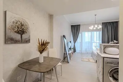 a living room with a table and a dining room at Stylish Studio apartment in Downtown Dubai in Dubai