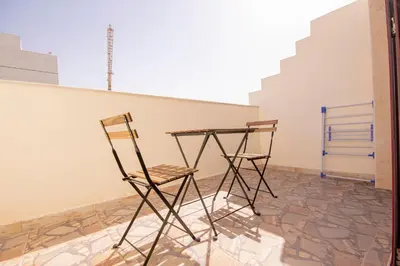 two chairs sitting next to a table in a room at Cozy Studio for Daily Rental Warsan in Dubai