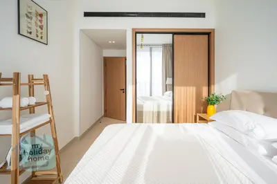 a bedroom with a bed and a sliding glass door at Fully furnished with stunning panoramic view in Dubai