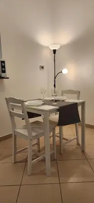 a white table with two wine glasses and two chairs at Marina Nest - Spacious one bed apt with a view in Marina, walking distance from JBR, metro & tram! in Dubai