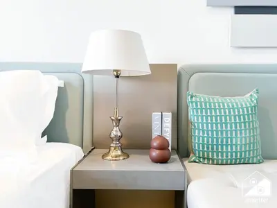 a lamp on a night stand next to a bed at Mag City 920 Modern Studio Minutes from Downtown in Dubai