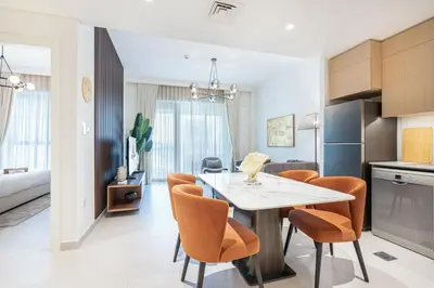 a kitchen and dining room with a table and chairs at Chic Bright Home in Creek Beach with Lagoon Access in Dubai