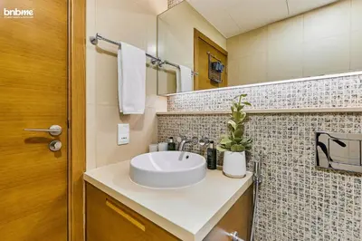 a bathroom with a sink and a mirror at bnbmehomes - Claren Tower in Dubai