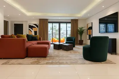 a living room with a couch and two chairs at Massive LuxXo Family & Friends Villa with Terraces, Private Parking, Pool & Quick Access to Dubai Mall in Dubai