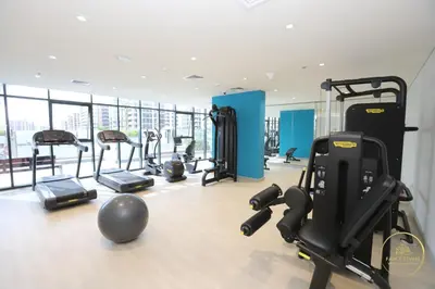 a gym with treadmills and exercise equipment in a building at Luxury 2-BHK Apartment Located in Azizi riviera 47 Riv 47-419 in Dubai