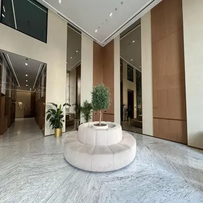 a lobby with a round table in the middle of a building at Luxurious Belvilla 1BR JVC with Pool, Gym & BBQ Access in Dubai