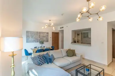 a living room with a couch and a table at Elegant 1BR At Sanibel Tower park Island Tower Dubai Marina by al sarya holiday homes in Dubai
