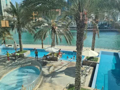 an overhead view of a swimming pool with palm trees at Elegant 1BR At Sanibel Tower park Island Tower Dubai Marina by al sarya holiday homes in Dubai