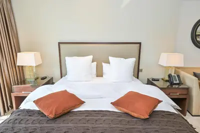 a bed in a hotel room with two pillows on it at Studio on the 30th Floor with Stunning Marina View in Dubai