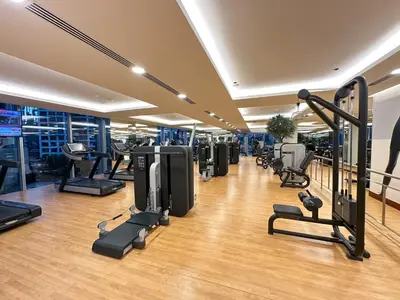 a gym with many treadmills and exercise equipment at Studio on the 30th Floor with Stunning Marina View in Dubai
