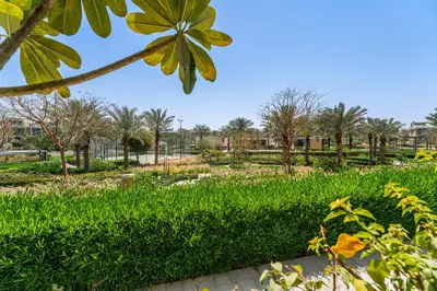 a park with green grass and trees in the background at Escape24 Elegant 2BR with Garden View in Dubai Hills in Dubai