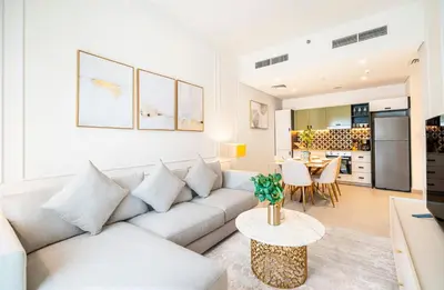 a living room with a couch and a table at Escape24 Elegant 2BR with Garden View in Dubai Hills in Dubai