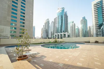 a swimming pool in a city with tall buildings at Cozy Chic Studio l Next to Marina Mall in Dubai