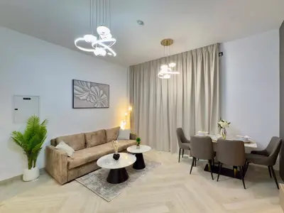 a living room with a couch and a table at Brand New-Fully Furnished Elegant 1BR In JVC in Dubai