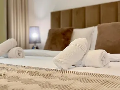 a pair of white socks on a bed at Brand New-Fully Furnished Elegant 1BR In JVC in Dubai