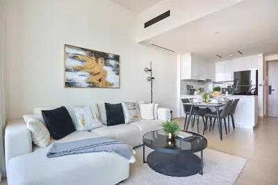 a living room with a couch and a table at Frank Porter - Binghatti Corner in Dubai