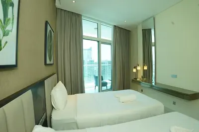 a hotel room with two beds and a window at Luxury 2BR Stay In Damac Prive near Dubai Mall in Dubai