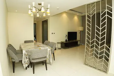 a dining room with a table and chairs at Luxury 2BR Stay In Damac Prive near Dubai Mall in Dubai