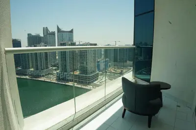 a chair sitting in front of a large window at Luxury 2BR Stay In Damac Prive near Dubai Mall in Dubai
