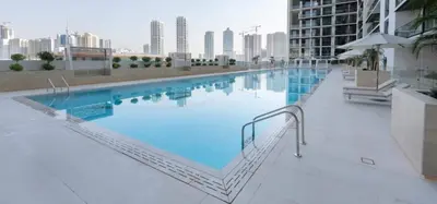 a large swimming pool on top of a building at Elegant Jvc 1br Balcony, Pool Access, Parking in Dubai