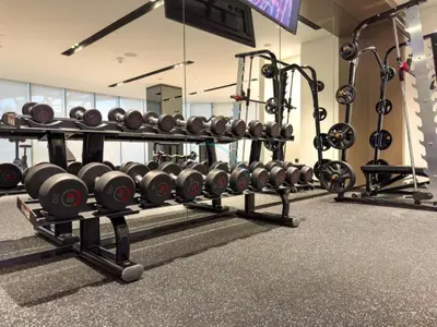 a gym with a rack of dumbbells and weights at City Vibe 1BR with Outdoor Space, Walking Distance to Burj Khalifa and Dubai Mall, Grande, Downtown Dubai by Deluxe Holiday Homes in Dubai