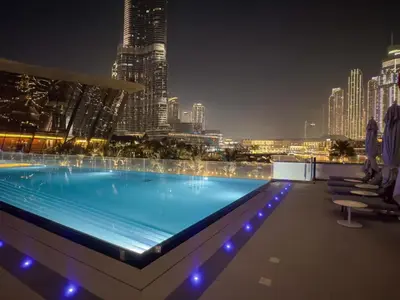 a swimming pool on top of a building with a city skyline at City Vibe 1BR with Outdoor Space, Walking Distance to Burj Khalifa and Dubai Mall, Grande, Downtown Dubai by Deluxe Holiday Homes in Dubai