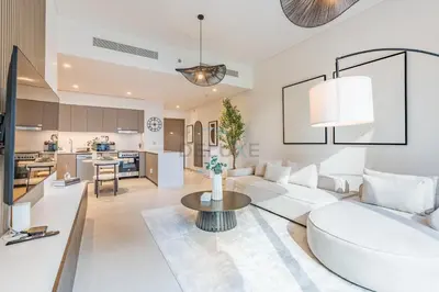 a living room with a white couch and a table at City Vibe 1BR with Outdoor Space, Walking Distance to Burj Khalifa and Dubai Mall, Grande, Downtown Dubai by Deluxe Holiday Homes in Dubai
