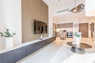 a kitchen and a living room with a table at City Vibe 1BR with Outdoor Space, Walking Distance to Burj Khalifa and Dubai Mall, Grande, Downtown Dubai by Deluxe Holiday Homes in Dubai