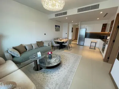 a living room with a couch and a table at Vida Dubai Marina Apartment at Prime Location in Dubai