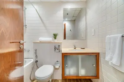 a bathroom with a toilet and a sink and a mirror at GuestReady - Contemporary living in Dubai Marina in Dubai