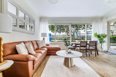 a living room with a brown couch and a table at GuestReady - Contemporary living in Dubai Marina in Dubai