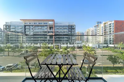 a picnic table and two chairs in front of a building at FIRST CLASS Studio Urban Elegance in Dubai
